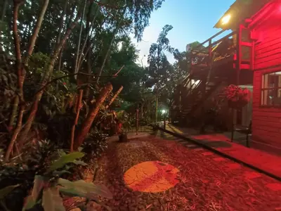 a path outside of a red building with trees at Loft campestre con terraza en el Poblado apt 113 in Medellín