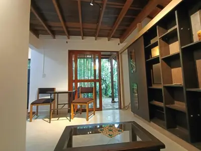 a living room with a table and chairs and a door at Loft campestre con terraza en el Poblado apt 113 in Medellín