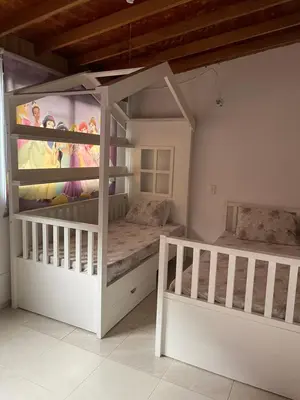 a bedroom with two bunk beds and a mural at Amplio apartamento en Niquia in Bello