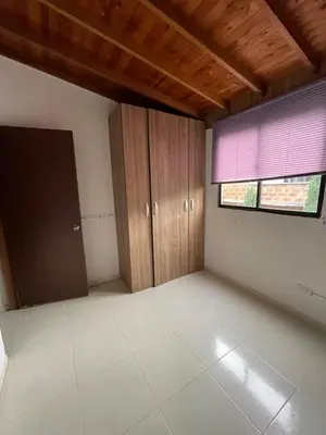 an empty room with wooden cabinets and a window at Amplio apartamento en Niquia in Bello