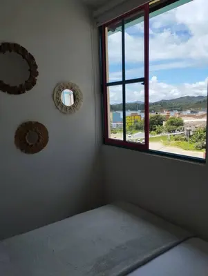 a room with a window and two mirrors on the wall at Apto Nuevo, Tranquilo, Bonito, 5 min Plaza Principal in Guatapé