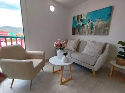 a living room with a couch and two chairs and a table at Apto Nuevo, Tranquilo, Bonito, 5 min Plaza Principal in Guatapé