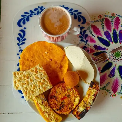 a plate of breakfast food with a cup of coffee at AZULEJO, Casa hotel campestre in Jericó