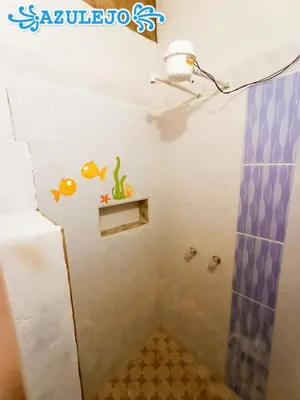 a bathroom with a shower with a fish sticker on the wall at AZULEJO, Casa hotel campestre in Jericó