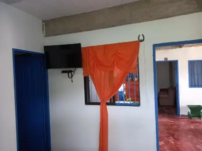 an orange curtain in a room with a window at AZULEJO, Casa hotel campestre in Jericó