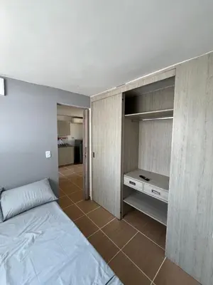 a bedroom with a bed and a cabinet in it at Laurel de Florida Apto in Medellín