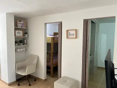 a living room with a chair and a mirror at Laurel de Florida Apto in Medellín