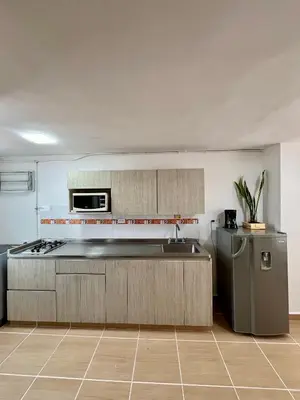 a kitchen with a sink and a refrigerator at Laurel de Florida Apto in Medellín
