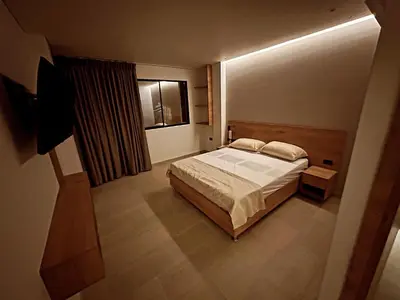 a bedroom with a bed and a window at Hotel La Casona San Sebastian in Doradal