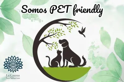 two cats and a dog sitting under a tree at Hotel La Casona San Sebastian in Doradal