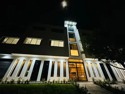 a building with a clock on top of it at night at Hotel La Casona San Sebastian in Doradal