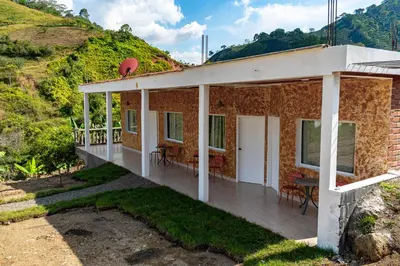 a house on a hill with a deck at Hotel Campestre La Francesina in Betania