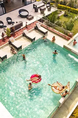 a group of people swimming in a large swimming pool at Vivanti Resort in Guatapé