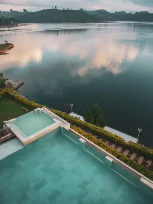 an aerial view of a swimming pool on a lake at Vivanti Resort in Guatapé