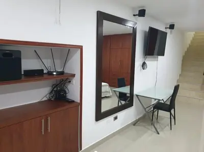 a mirror in a room with a table and a mirror at Hospedajes Pilarica in Medellín