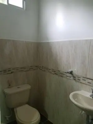 a bathroom with a toilet and a sink at Hospedajes Pilarica in Medellín