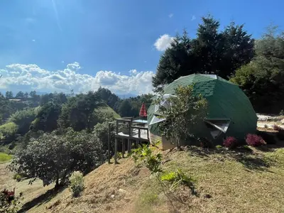 a green dome tent on top of a hill at Vitta Glamping in Rionegro