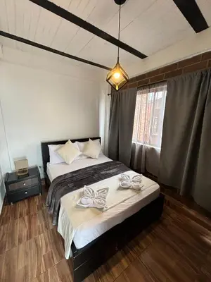a bedroom with two beds with bows on them at Hostal Del Cielo in Medellín