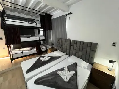 a bedroom with a bed with a butterfly on it at Hostal Del Cielo in Medellín