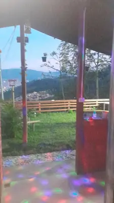 a view from a window of a park with a fence at Casita el mirador solo naturaleza in Medellín