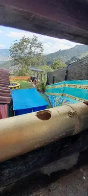 a view of a group of blue tables with a view of a mountain at Casita el mirador solo naturaleza in Medellín
