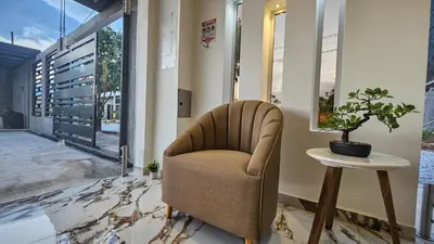 a chair in a hallway with a table and a plant at ZAFIRO HOTEL in Doradal