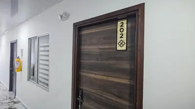 a wooden door with a sign on it at ZAFIRO HOTEL in Doradal