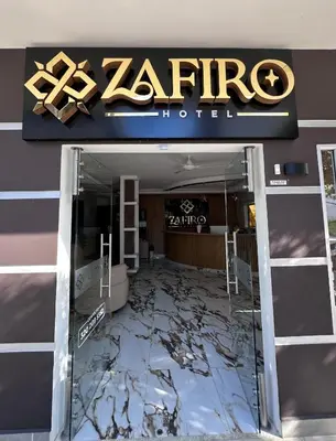 a store front with a z rite sign and a glass door at ZAFIRO HOTEL in Doradal