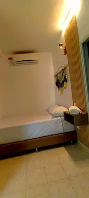 a small bedroom with a bed and a air conditioner at HOTEL BOHO BOUTIQUE in Quibdó