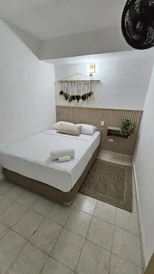 a bedroom with a large bed in a room at HOTEL BOHO BOUTIQUE in Quibdó