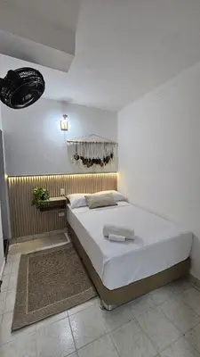 a bedroom with a large white bed in a room at HOTEL BOHO BOUTIQUE in Quibdó