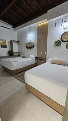 two beds in a room with two beds sidx sidx sidx at HOTEL BOHO BOUTIQUE in Quibdó
