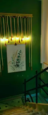 a green wall with a picture and lights on it at HOTEL BOHO BOUTIQUE in Quibdó