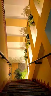 a staircase in a building with plants on the ceilings at HOTEL BOHO BOUTIQUE in Quibdó