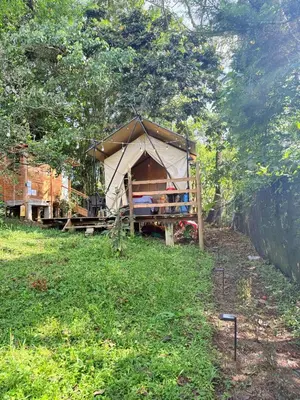 a large tent in a field of grass at Glamping Colibrí, bosque vecino y vista a la montaña al mismo tiempo in Jardin