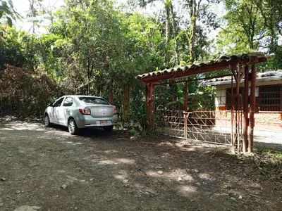 a car parked next to a house with a gate at Glamping Colibrí, bosque vecino y vista a la montaña al mismo tiempo in Jardin