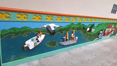 a wall with a painting of people on a river at HOSPEDAJE VILLA SAMARA --- cerca de la piedra -- GUATAPÉ in Guatapé