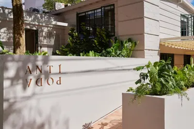 a sign for an art school in front of a building at Antipoda Hotel Boutique in Medellín