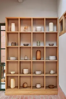a wooden shelf with bowls and dishes on it at Antipoda Hotel Boutique in Medellín