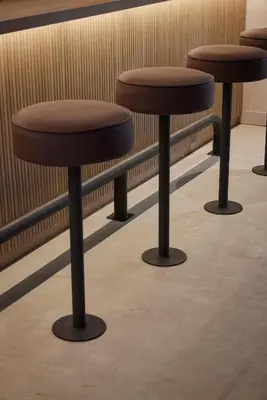 a row of stools in a waiting room at Antipoda Hotel Boutique in Medellín