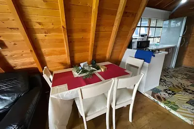 a dining room with a table and chairs in a kitchen at Cabaña Entre Aguacates, Refugio en Marinilla in Marinilla