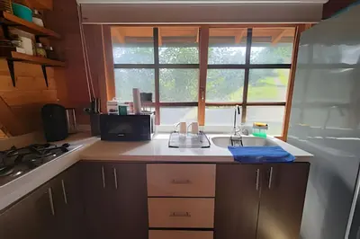 a kitchen with a counter with a sink and a window at Cabaña Entre Aguacates, Refugio en Marinilla in Marinilla