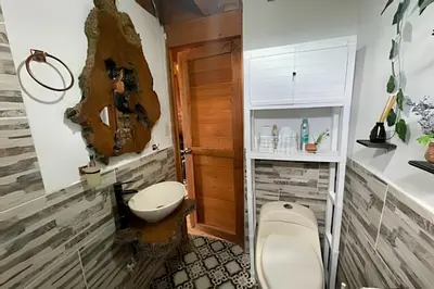 a bathroom with a toilet and a sink at Cabaña Entre Aguacates, Refugio en Marinilla in Marinilla