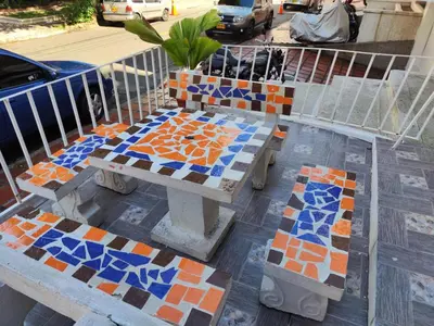 a bench with colorful tiles on it on a sidewalk at Absolute Hotel & Hostel Boutique in Medellín