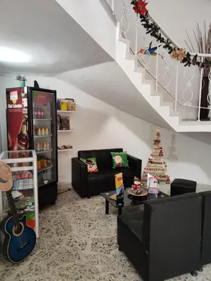 a living room with two couches and a guitar at Absolute Hotel & Hostel Boutique in Medellín