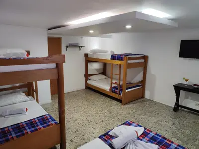 a room with two bunk beds and a flat screen tv at Absolute Hotel & Hostel Boutique in Medellín