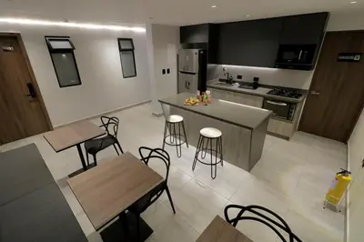 an aerial view of a kitchen with tables and chairs at Casa Moderna Laureles con Jacuzzi y 7 Baños in Medellín