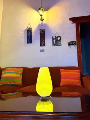 a living room with a couch and a yellow lamp at Casa & cabaña campestre equipadas, 13 personas, familias in Jardin