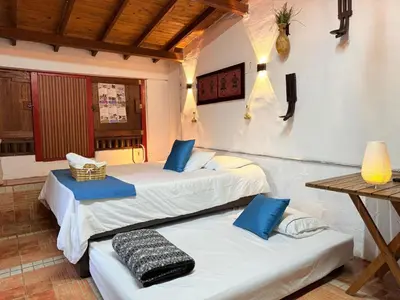 a room with two beds and a table at Casa & cabaña campestre equipadas, 13 personas, familias in Jardin