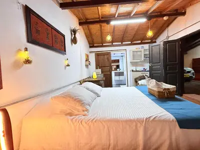 a bedroom with a large bed in a room at Casa & cabaña campestre equipadas, 13 personas, familias in Jardin